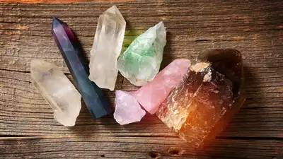 Assorted crystals for healing on a wooden surface, showcasing the benefits of healing crystals like amethyst, rose quartz, and clear quartz.